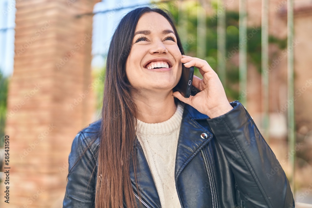 Young woman smiling confident talking on the smartphone at street Young woman smiling confident talking on the smartphone at street