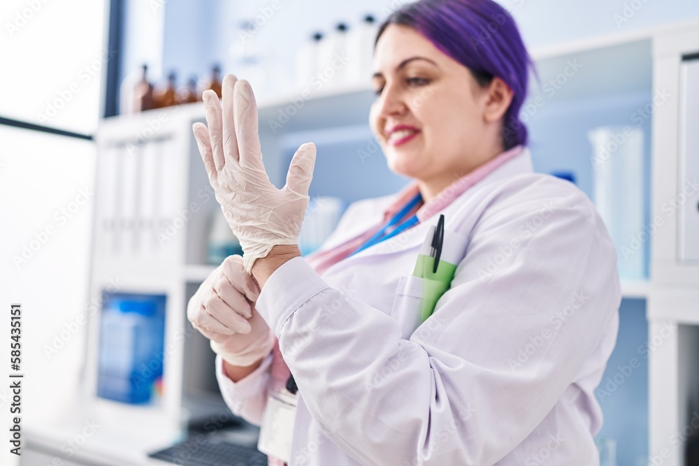 Young beautiful plus size woman scientist smiling confident wearing gloves at laboratory Young beautiful plus size woman scientist smiling confident wearing gloves at laboratory