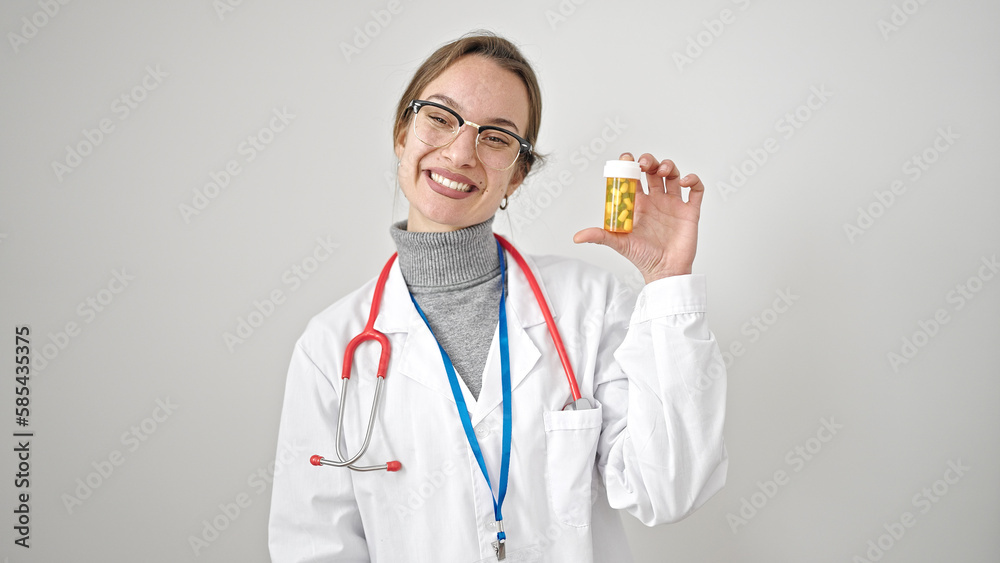 Young caucasian woman doctor holding pills over isolated white background Young caucasian woman doctor holding pills over isolated white background