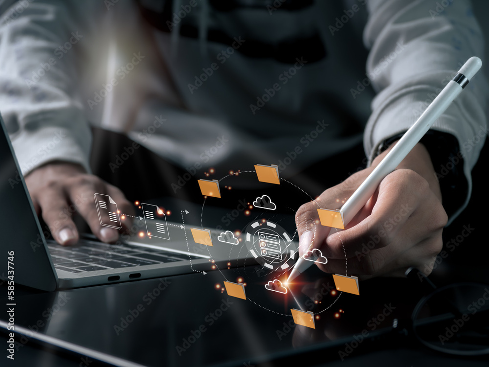 Fotka „A multitasking businessman is using a laptop computer, and an IT ...