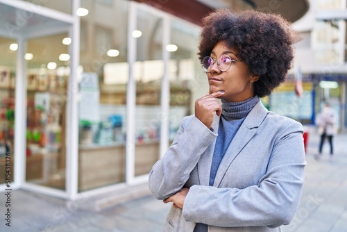 African american woman executive standing with doubt expression at street