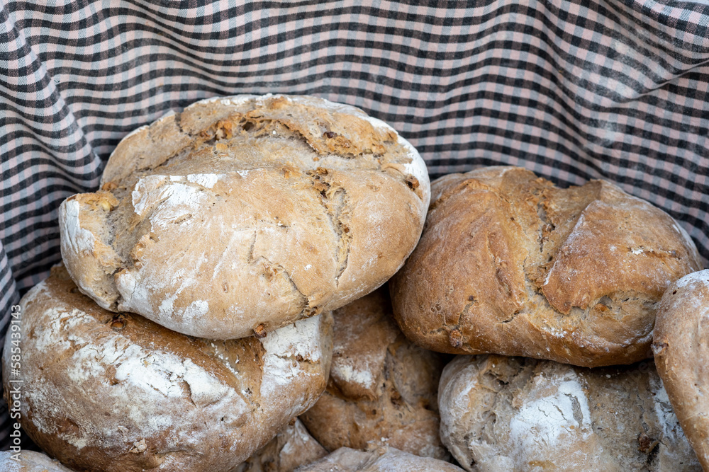 A basket of freshly-baked, artisan sourdough bread sits in a high angle view - perfect for healthy eating and tasty fast food.