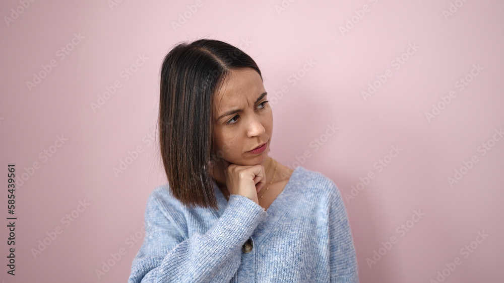 Young beautiful hispanic woman standing with doubt expression over isolated pink background Young beautiful hispanic woman standing with doubt expression over isolated pink background