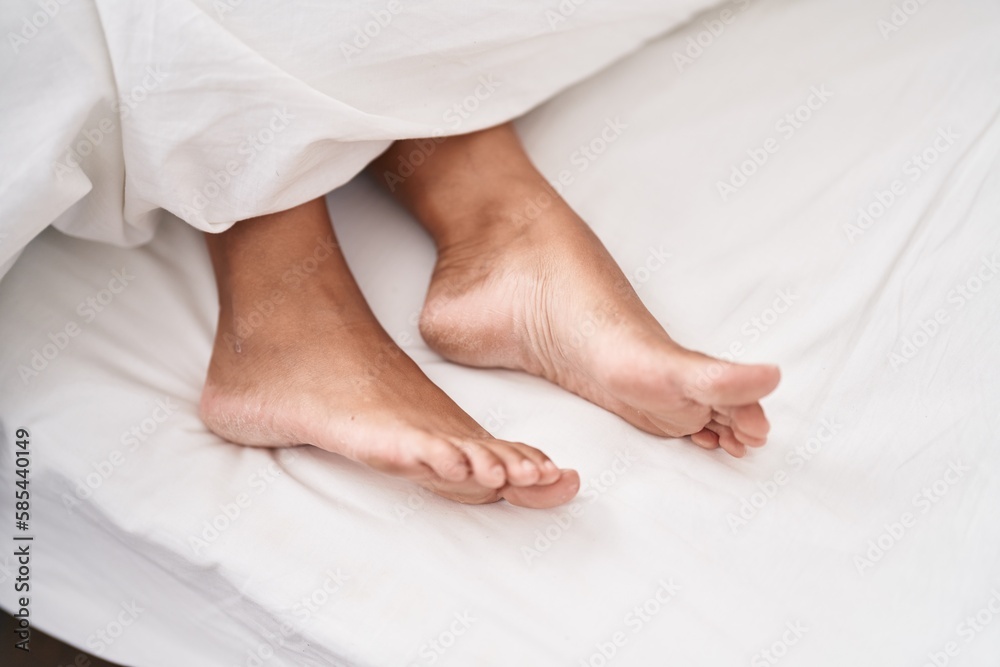 Young beautiful hispanic woman lying on bed at street