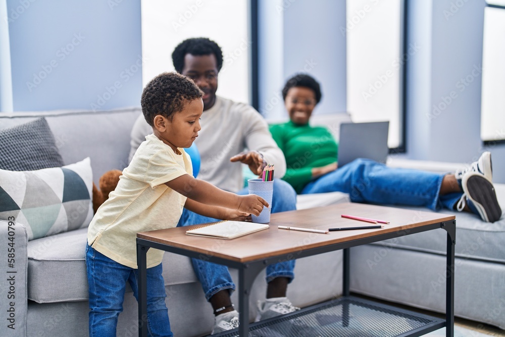 African american family drawing on notebook at home African american family drawing on notebook at home
