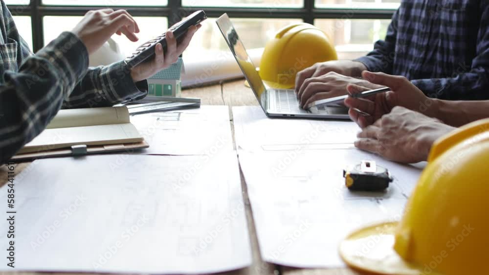 Architect team meeting, Group of architects and contractor engineers meet to discuss the design and layout of the construction project.