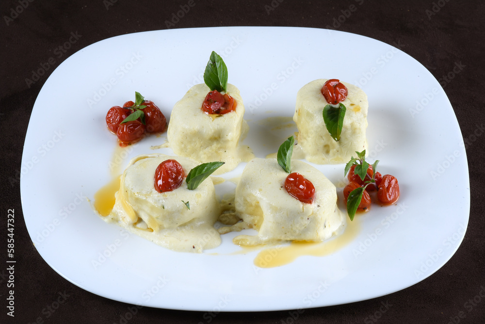 italian food cannelloni pasta with white sauce and tomatoes italian food cannelloni pasta with white sauce and tomatoes