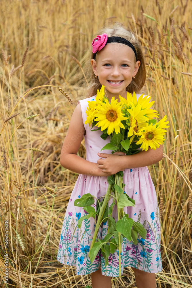 Happy Cute Little Girl Holding the Bouquet of Sunflowers in Hands in Wheat Field Happy Cute Little Girl Holding the Bouquet of Sunflowers in Hands in Wheat Field