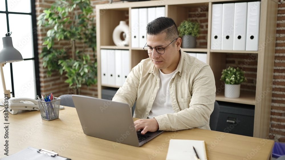 Young hispanic man business worker using laptop at office Young hispanic man business worker using laptop at office
