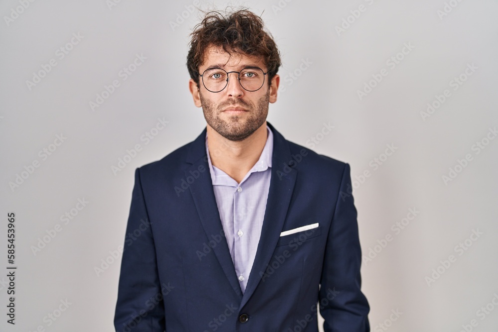 Hispanic business man wearing glasses relaxed with serious expression on face. simple and natural looking at the camera. Hispanic business man wearing glasses relaxed with serious expression on face. simple and natural looking at the camera.
