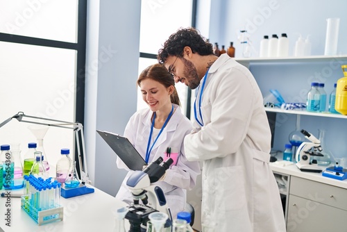 Man and woman scientist partners working at laboratory