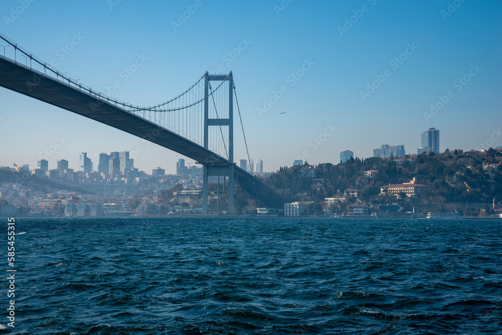 The Bosphorus Bridge across the Strait on a sunny and foggy day.