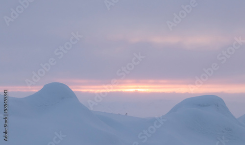 orange sunset in snowy mountains © Ivan