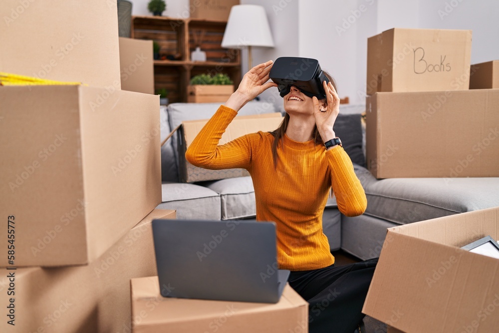 Young caucasian woman playing video game using virtual reality glasses at new home Young caucasian woman playing video game using virtual reality glasses at new home