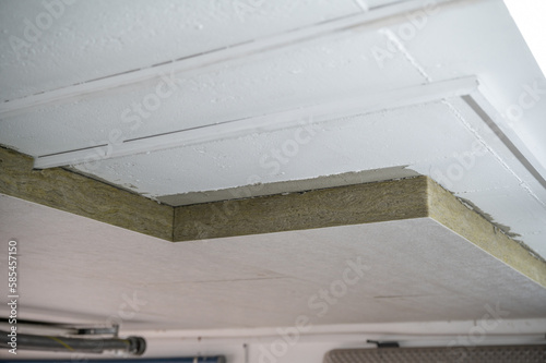Insulation panels made of mineral wool, which were glued under a basement ceiling