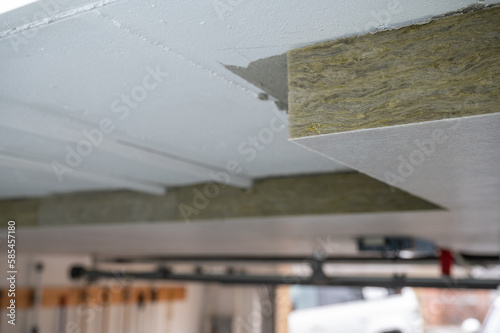 Insulation panels made of mineral wool, which were glued under a basement ceiling