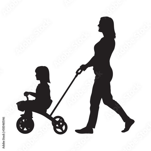 Young mother pushing daughter on tricycle outdoor silhouette.