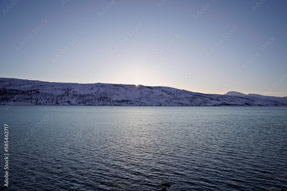 sunset time in fjords of tromso, norway