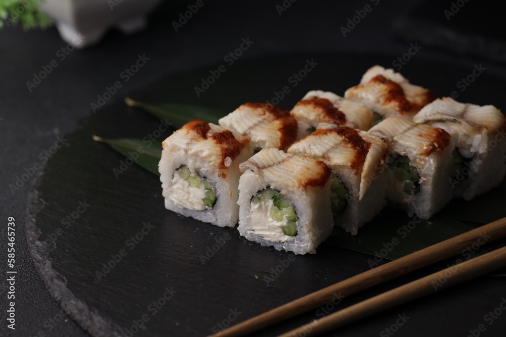 Sushi rolls on black background with salmon cheese and fish Sushi rolls on black background with salmon cheese and fish