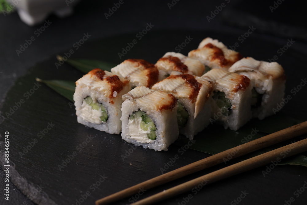 Sushi rolls on black background with salmon cheese and fish Sushi rolls on black background with salmon cheese and fish