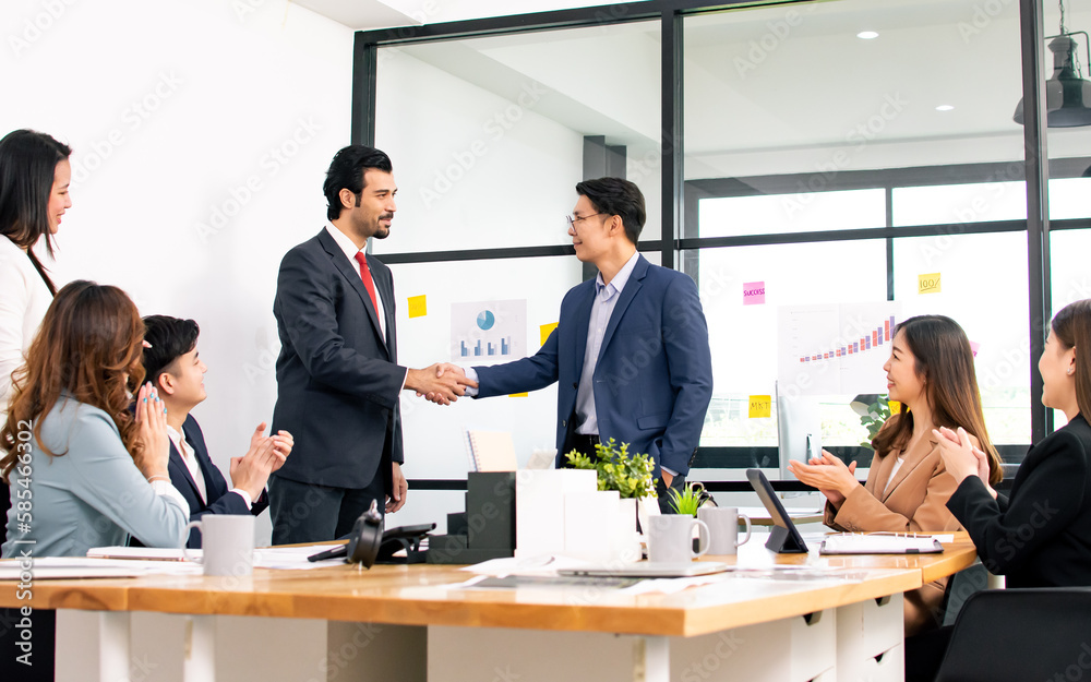 Group of business people applause and congrat while two men shaking their hand after making deal or agreement. Working and Success Concept.. Group of business people applause and congrat while two men shaking their hand after making deal or agreement. Working and Success Concept..