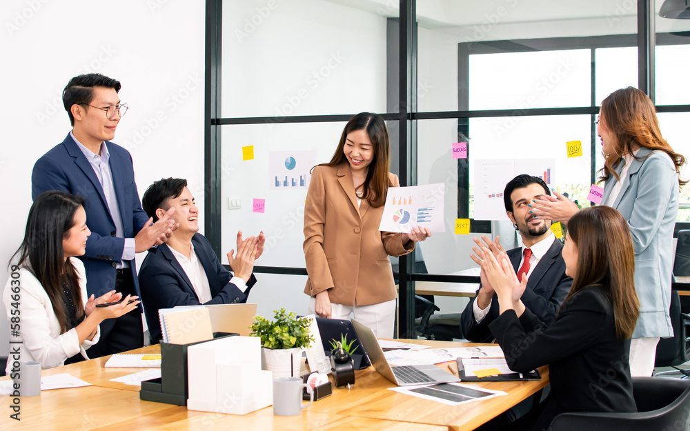 Asian beautiful business woman wearing formal suit, discussing and presenting financial graph or chart to her mixed race colleagues in meeting room at indoor office or workplace. Asian beautiful business woman wearing formal suit, discussing and presenting financial graph or chart to her mixed race colleagues in meeting room at indoor office or workplace.