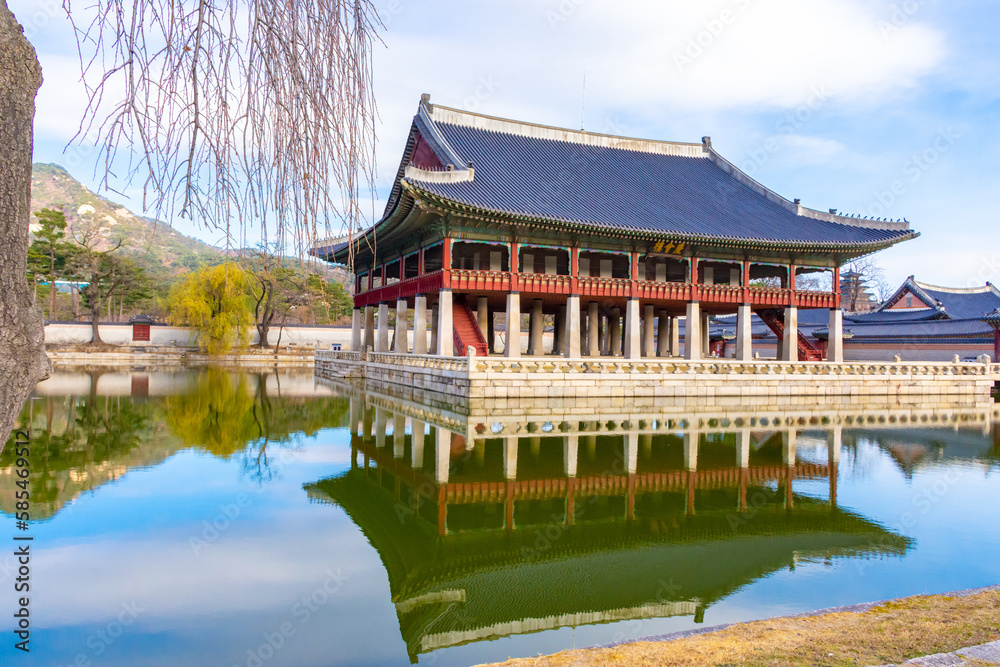 View of Gyeonghoeru, a royal banquet hall at Gyeongbokgung Palace with blue sky and lake in the background