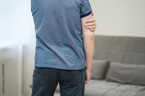 Diseases of the elbow joint, bone fracture and inflammation, man suffering from pain in cubit photo