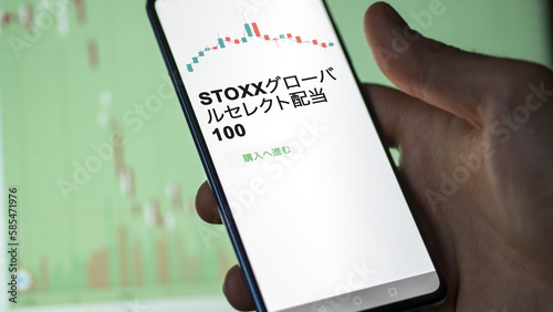 Investor analyzing an ETF. Funds stocks exchange ETFs Japanese text: stoxx Global Select Dividend 100, buy. STOXXグローバルセレクト配当100 証券取引所 投資 shares photo