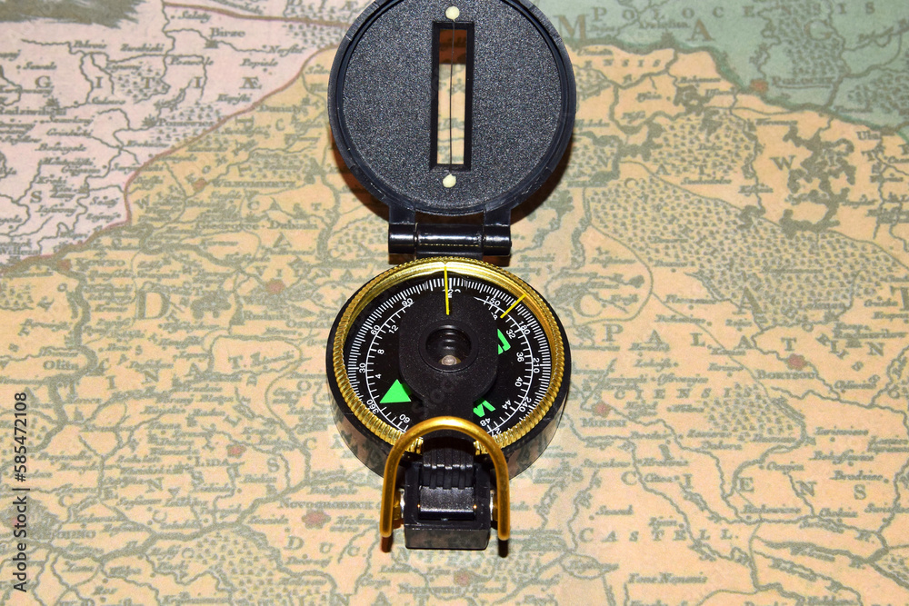 Army compass lies on an old physical map Army compass lies on an old physical map