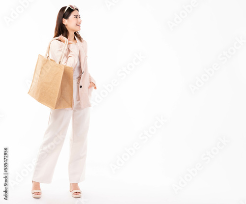 Young woman in suit and eyeglasses hold shopping bag with purchases isolated on white background studio portrait Shopping discount sale Young Business lady look at copy space with happy and smile face