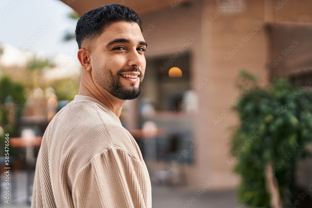 Young arab man smiling confident standing at street Young arab man smiling confident standing at street