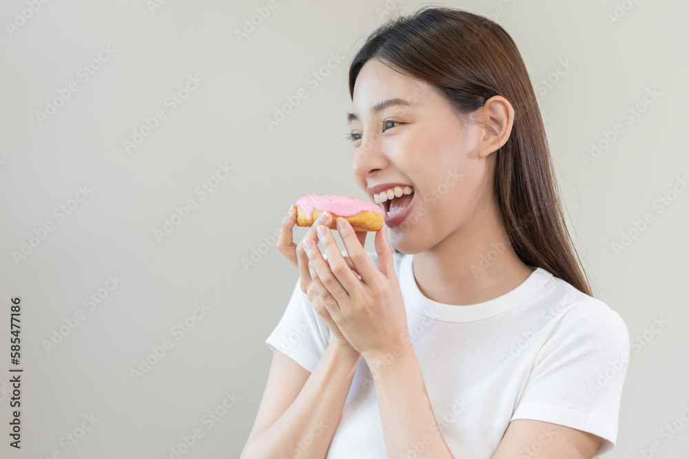 Portrait of attractive beautiful girl, pretty asian young teenage woman holding pink donut, doughnut, emotion enjoy sweet. Dieting, diet for loss weight to slim. Isolated white background, copy space. Portrait of attractive beautiful girl, pretty asian young teenage woman holding pink donut, doughnut, emotion enjoy sweet. Dieting, diet for loss weight to slim. Isolated white background, copy space.