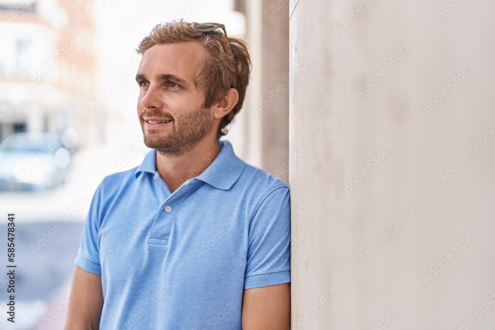 Young man smiling confident looking to the side at street Young man smiling confident looking to the side at street