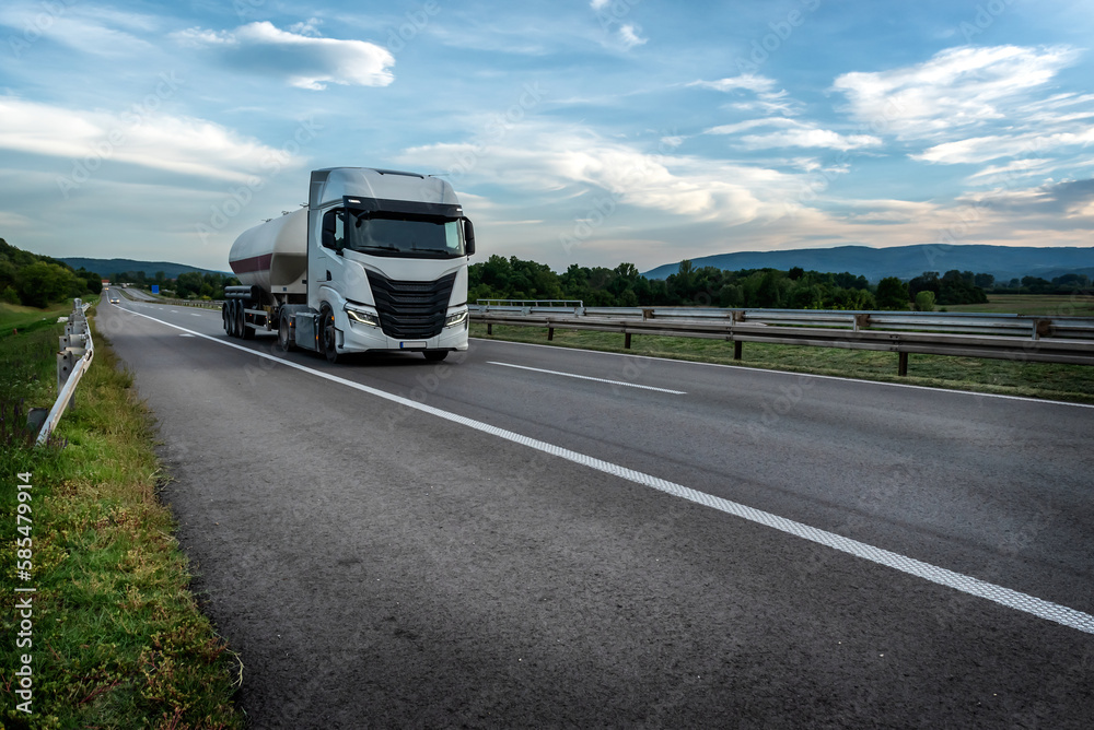 Tanker or Tank Truck on a highway road under blue sunrise sky