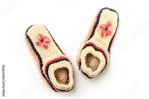 White knitted woolen slippers on a white background close-up.