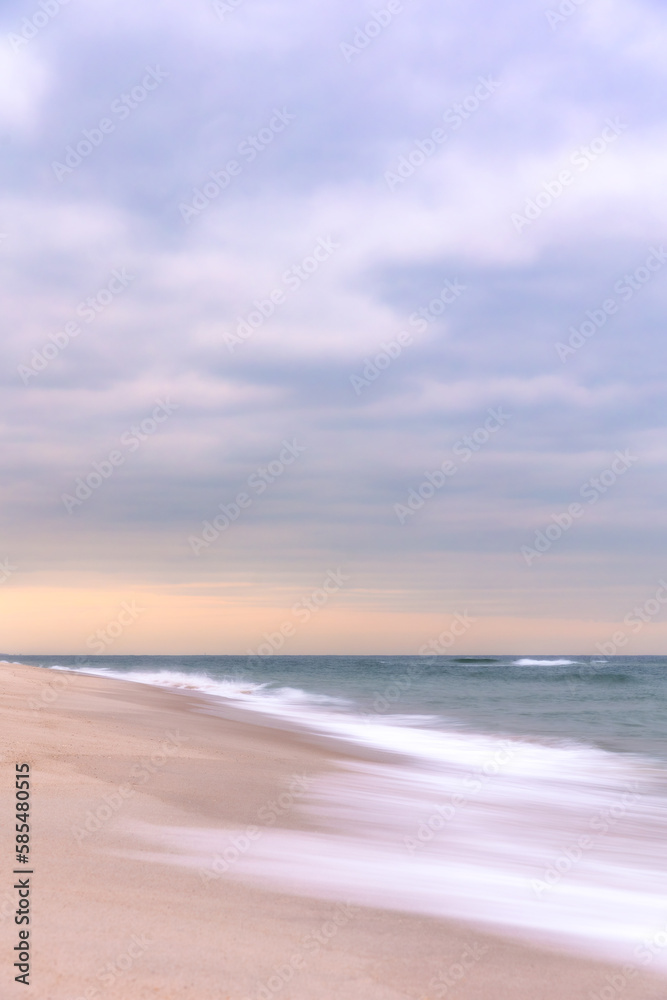 Soft silky waves receding back to the ocean on a peaceful beach - Long Island New York