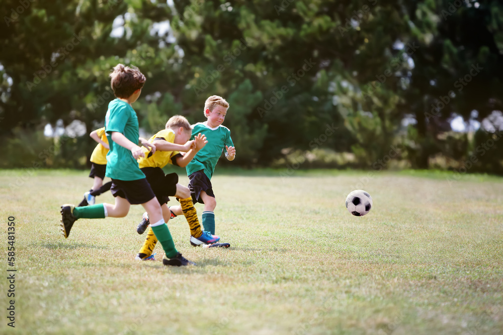 Obraz premium Young boys running after the ball during a soccer game