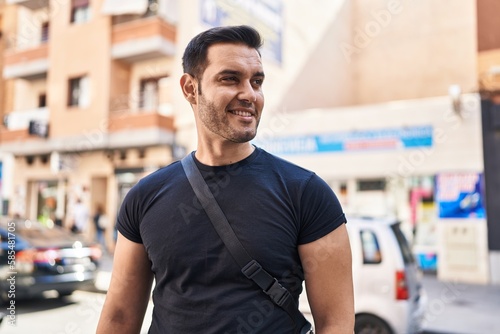 Young hispanic man smiling confident standing at street © Krakenimages.com