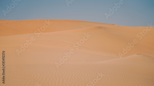 Sand dunes in the desert with a light on the top