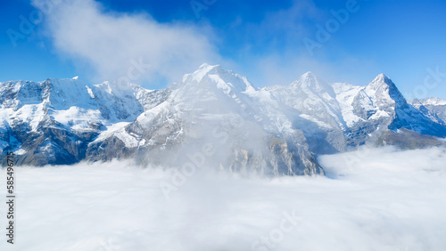 Natural background. Mountains and clouds in the valley. Natural landscape high in the mountains. Mountain range through the clouds.