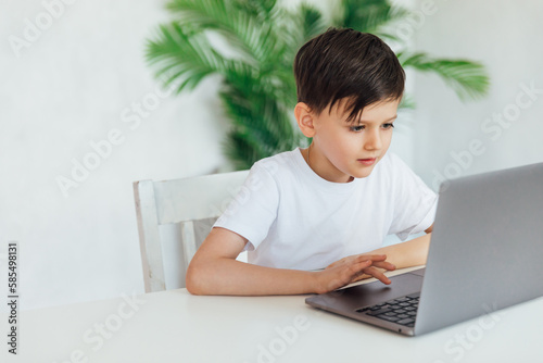 education online online games boy sits at the computer in the office