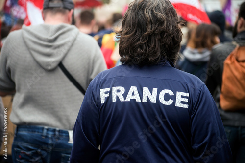 closeup of Man walking in the street with France tee- shirt