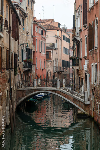 Venice, view of a canal on a misty day, bridge over canal in the background. © Salvati Photography