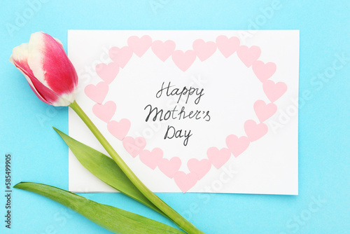 Text Happy Mother's Day with tulip flower on blue background