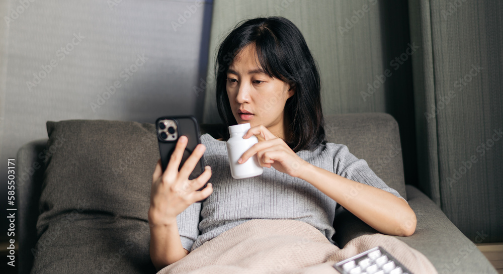 Sick asian woman with medicine having video call conference for advising with medical app in telehealth on mobile phone. Healthcare, technology and people concept Sick asian woman with medicine having video call conference for advising with medical app in telehealth on mobile phone. Healthcare, technology and people concept