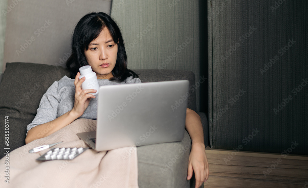Sick asian woman with medicine having video call conference medical app in telehealth on laptop. Healthcare, technology and people concept Sick asian woman with medicine having video call conference medical app in telehealth on laptop. Healthcare, technology and people concept