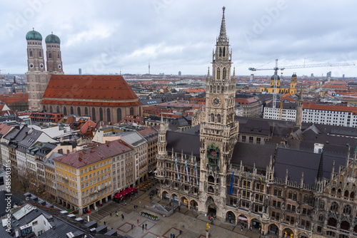 View from the bell tower of the church of saint Peter of the city of Munich  where you can see the cathedral and the town hall  on a cloudy and rainy day.