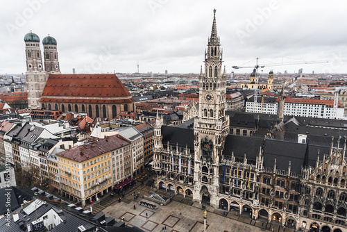 View from the bell tower of the church of saint Peter of the city of Munich  where you can see the cathedral and the town hall  on a cloudy and rainy day.