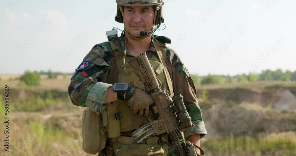 asian anonymous soldier in camouflage has rest, standing on mountain slow motion asian anonymous soldier in camouflage has rest, standing on mountain slow motion